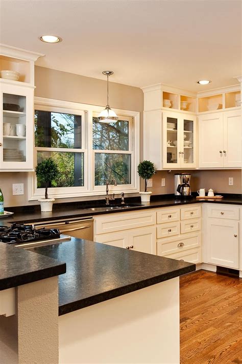 white kitchen cabinets with black countertops